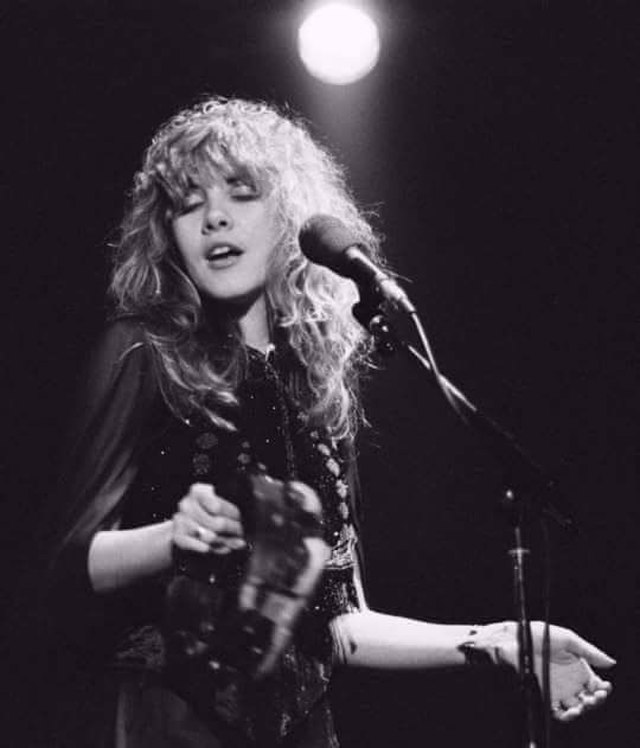 This photograph was taken on February 1st, 1980, while Stevie Nicks was on tour for Tusk. It features her playing the tambourine, an instrument that she picked up during her time with Fritz, in order to give her something to do on stage. She stuck with playing it throughout her career, making it an iconic part of her image. 
(Photo Credit: Awil916, CC BY-SA 4.0 , via Wikimedia Commons)
