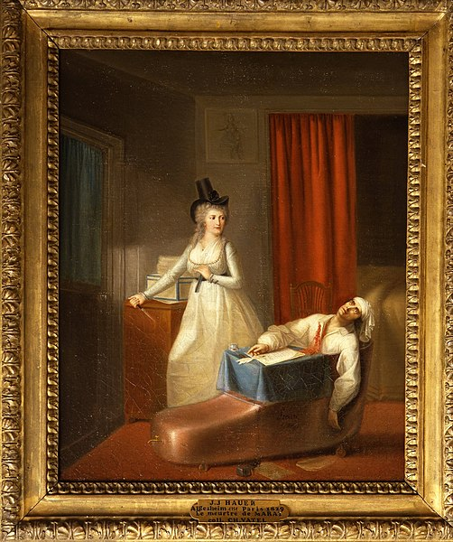  La mort de Marat was painted by Jean-Jacques Hauer shortly after Marats assassination. This portrait looks at Charlotte Corday in a sympathetic light as a brave revolutionary on a mission. In this portrayal of Corday, she has blond hair, whereas in reality, Corday was a brunette. The reason for this choice was allegedly for Hauer’s safety, as light hair symbolized the vilified aristocracy.
(Photo Credit: Jean-Jacques Hauer, Public domain, via Wikimedia Commons)