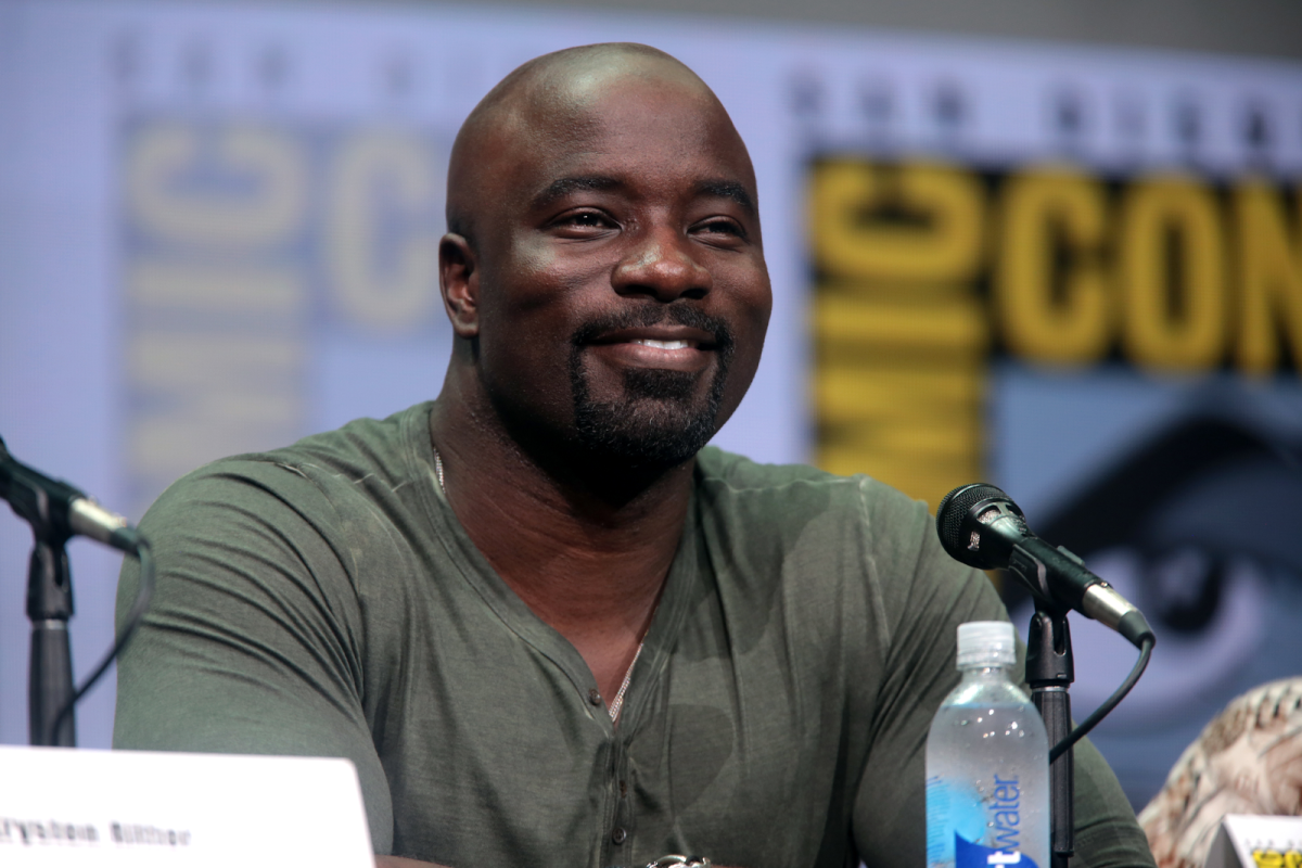 Mike Colter is known for his notable achievements, including his critically acclaimed portrayal of Marvels Luke Cage, which brought depth and charisma to the iconic character, and his versatile performances in various television series and films, showcasing his remarkable range and talent in the entertainment industry. 
(Photo Credit: Gage Skidmore from Peoria, AZ, United States of America, CC BY-SA 2.0 , via Wikimedia Commons)
