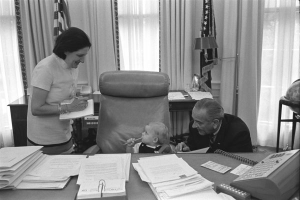 Helen Thomas, the first female member of the White House press corps is enjoying a moment of levity with President Lyndon B. Johnson and his grandson in the Oval Office in 1968. Thomas was a pioneer for women in her field and worked under the administrations of ten U.S. presidents. (Photo Credit: LBJ Library photo by Yoichi Okamoto, Public domain, via Wikimedia Commons)