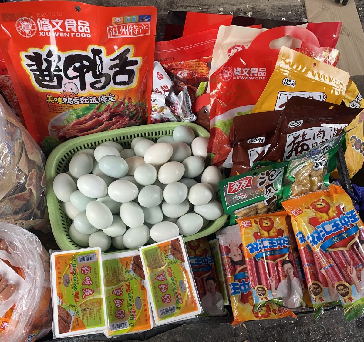 Chinese food like duck blood, duck eggs, sausages, and snacks are sold near the Long Island Railroad station.