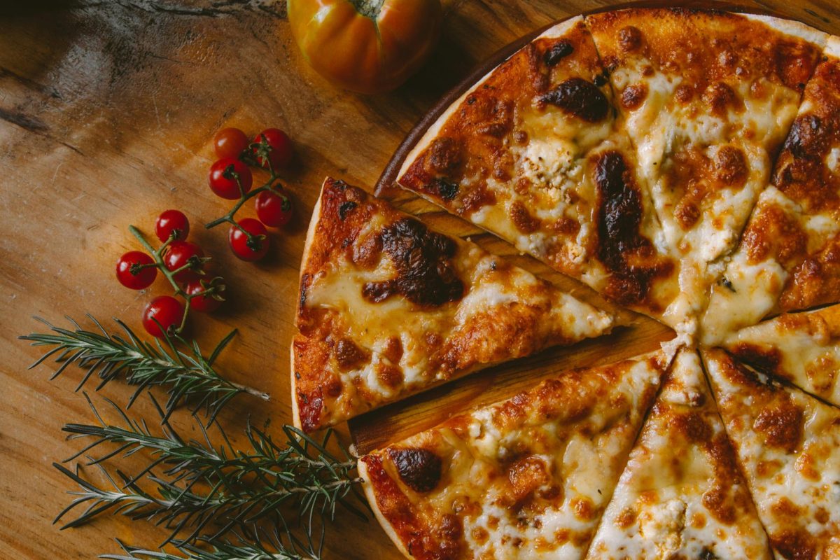 Here is a warm pizza topped with traditional and simple toppings. Without the invention of the pizza box, you would have no way to take it home or have it delivered. (Photo Credit: Ivan Torres / Unsplash)