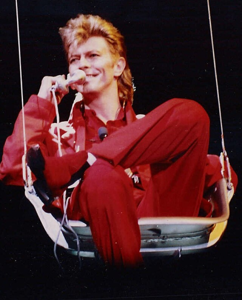 Here is David Bowie during a concert in 1987. Was he flamboyant, eccentric, extraterrestrial, or all of the above? (Photo Credit: Elmar J. Lordemann (de:User:Jo Atmon), CC BY-SA 2.0 DE , via Wikimedia Commons)
