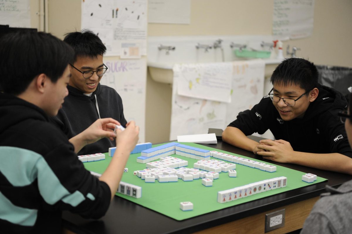 Members of the  East Asian Games Club play Mahjong, a board game in which players compete to remove tiles by matching identical pairs.