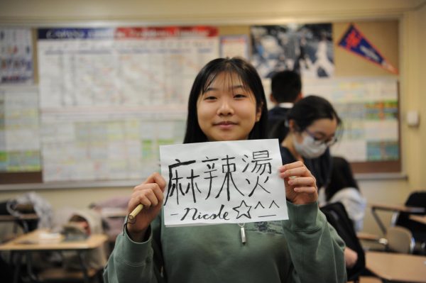 Members of Chinese Cultural Club engage in Chinese calligraphy, where they write their name with artistic technique. 
