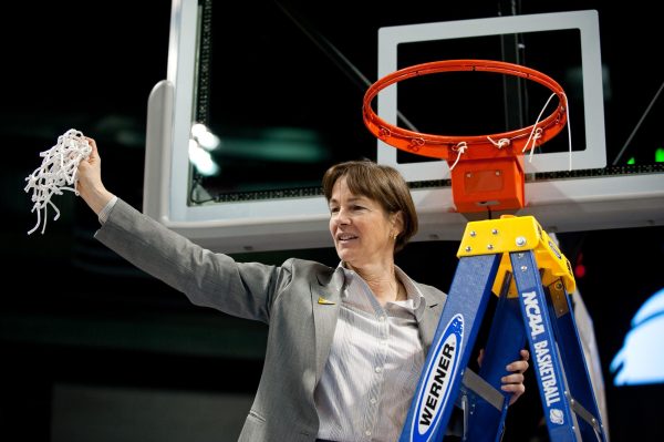 Here, Tara VanDerveer cuts down the net at the 2011 NCAA tournament at the end of the Spokane Regional. Her team, the Stanford Cardinal, won the region, and advanced to the Final Four. (Photo Credit: Don Feria, CC BY-SA 3.0 