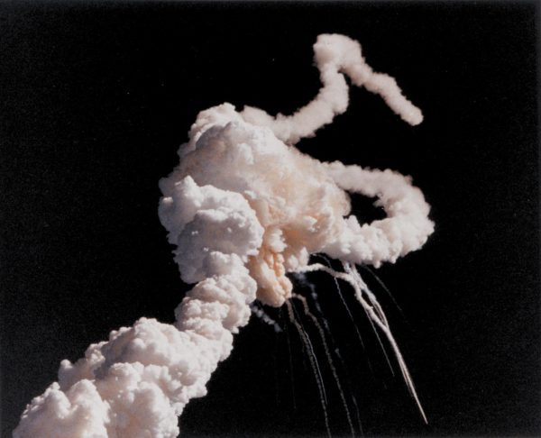 On January 28, 1986, the Space Shuttle Challenger broke apart 73 seconds into its flight, killing all seven crew members aboard. Challenger’s solid rocket boosters flew uncontrollably after the breakup of the external tank separated them from the shuttle stack. (Kennedy Space Center, Public domain, via Wikimedia Commons)