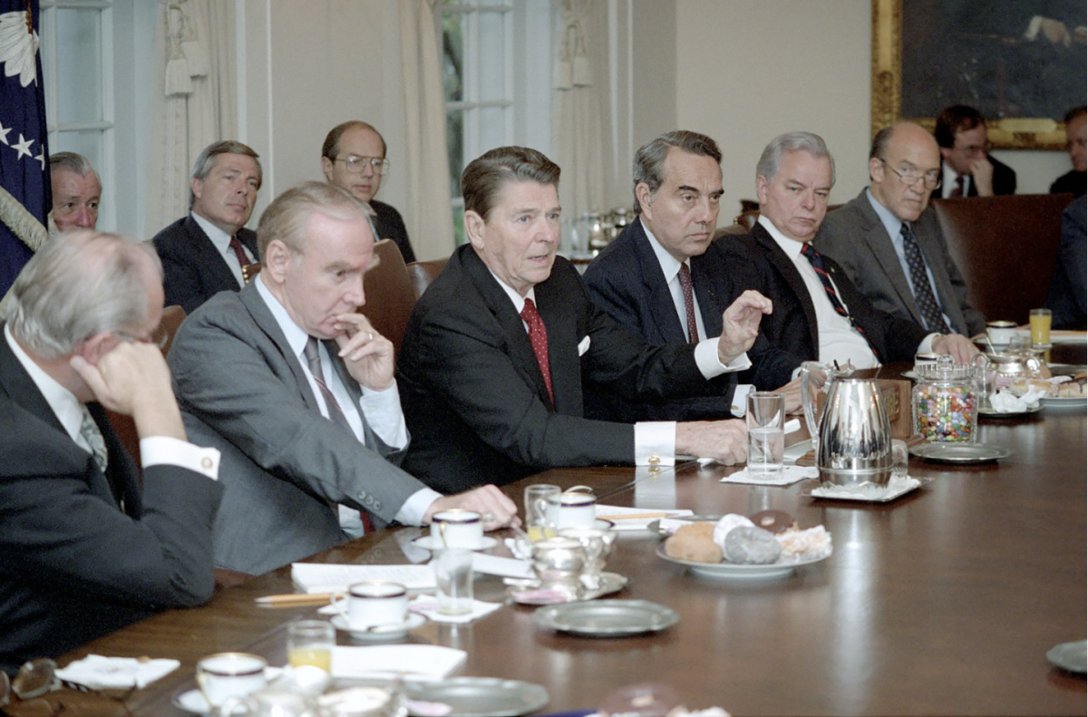 Pictured is former President Ronald Reagan leading a bipartisan Congressional Leadership meeting in a Cabinet room. (Photo Credit: Series: Reagan White House Photographs, 1/20/1981 - 1/20/1989Collection: White House Photographic Collection, 1/20/1981 - 1/20/1989, Public domain, via Wikimedia Commons)

