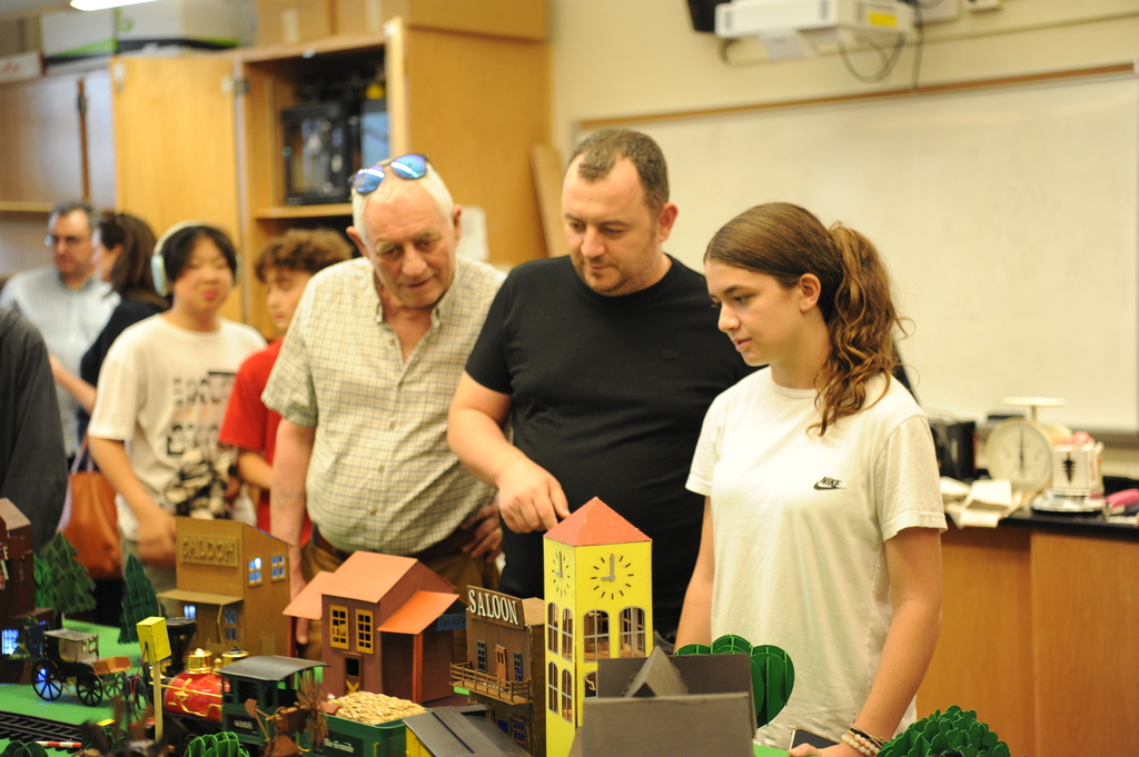 Prospective students and their families observe the projects designed by current students in the Engineering Design Lab.