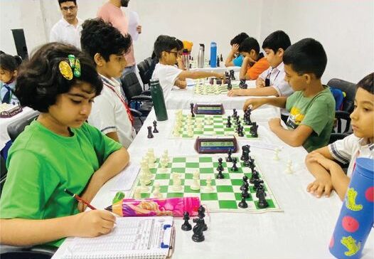  In a national kid’s chess tournament, only one girl is visibly playing in a room full of boys, displaying how gender gaps in chess begin at an extremely young age. (Photo Credit: Pacifciworldschool, CC BY-SA 4.0 , via Wikimedia Commons)
