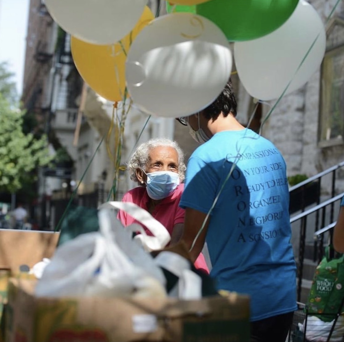 A volunteer helps a client at the food pantry. (Photo Credit: Used by permission from @theimaginesociety)