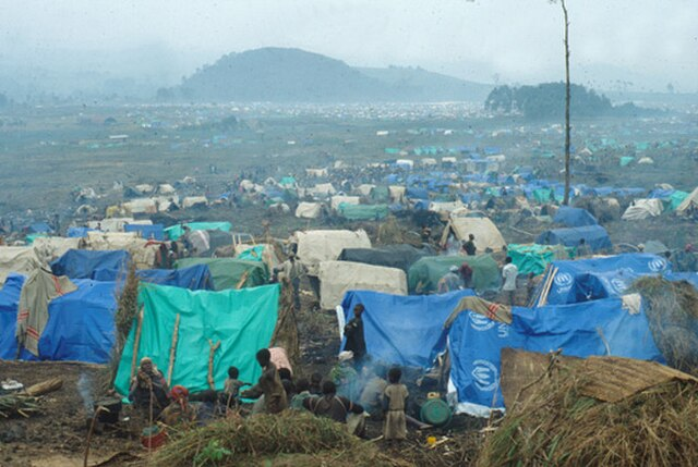 Here is a Rwandan refugee camp in east Zaire. During the Rwandan genocide, many citizens (both Hutus and Tutsis) felt as though it was no longer safe to live in the country, resulting in a large number of Rwandans fleeing to nearby refugee camps in other nations. One big receiver of Rwandan refugees is Zaire, keeping more than 1 million Hutus in the Katale, Kahindo, Mugunga, Lac Vert and Sake camps. (Photo Credit: CDC, Public domain, via Wikimedia Commons)