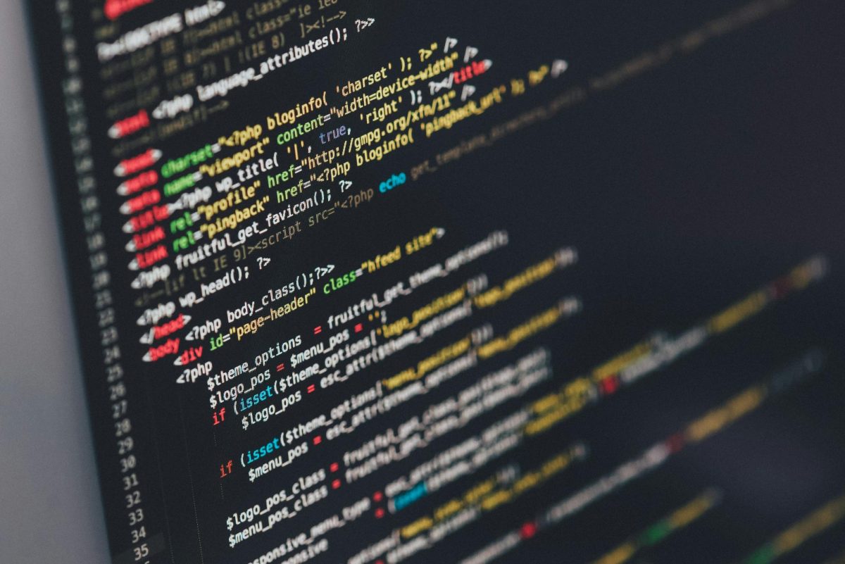 Modern day coding, as seen in this photograph, has a long history. (Photo Credit: Ilya Pavlov / Unsplash)