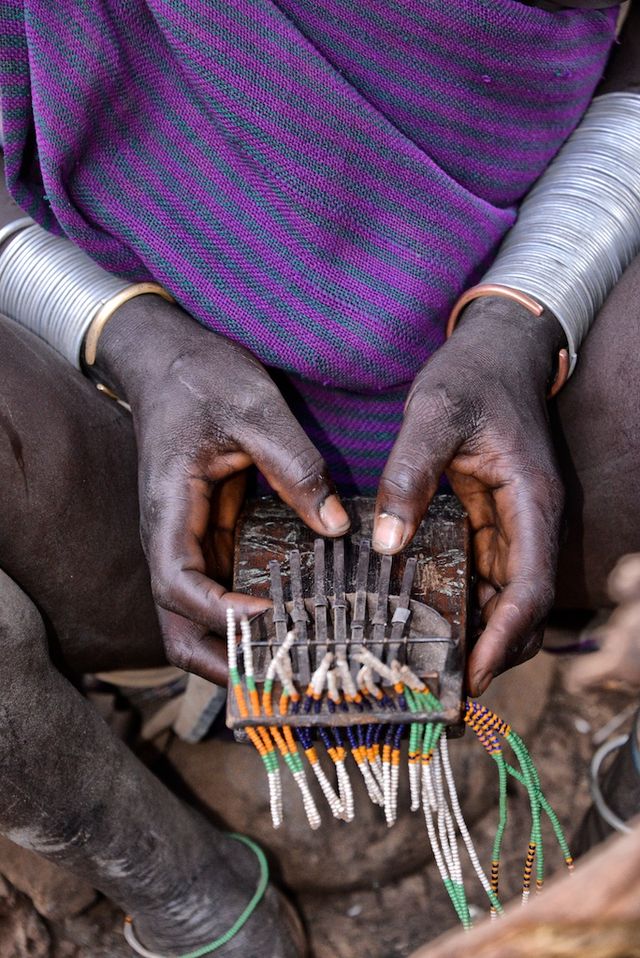 A pair of weathered hands delicately grips a kalimba, a traditional African thumb piano. This image represents the way the beauty of the kalimba has been passed down from generation to generation throughout history. (Photo Credit: Rod Waddington from Kergunyah, Australia, CC BY-SA 2.0 , via Wikimedia Commons)