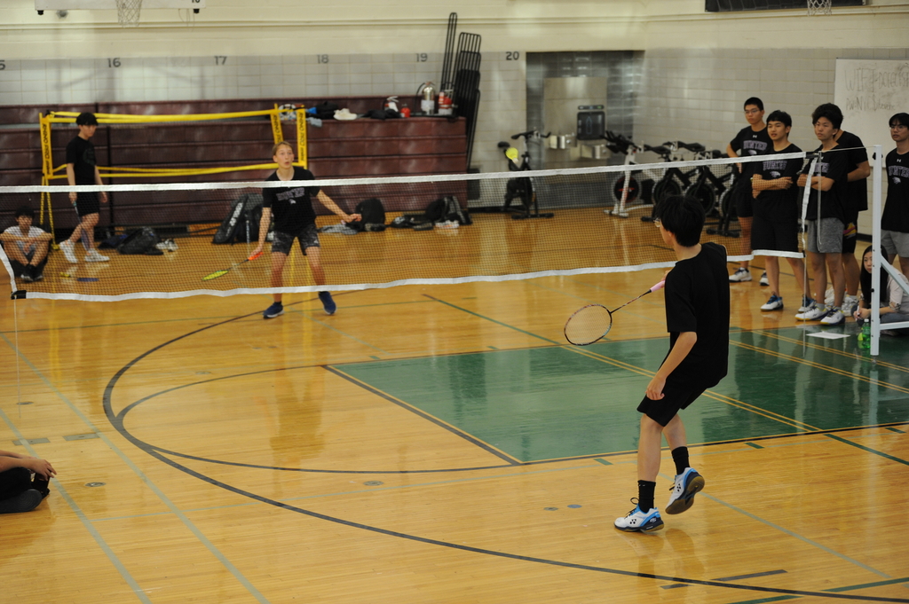 A Bronx Science team member and an opposing team member play in the middle of a singles round. 