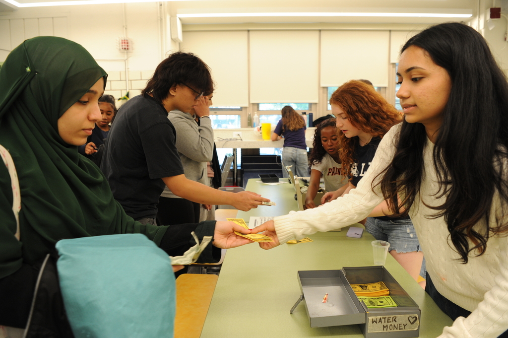 Students were required to use LOP dollars to buy any food. Here, members of the LOP exchange money with students in the back of the cafeteria. 