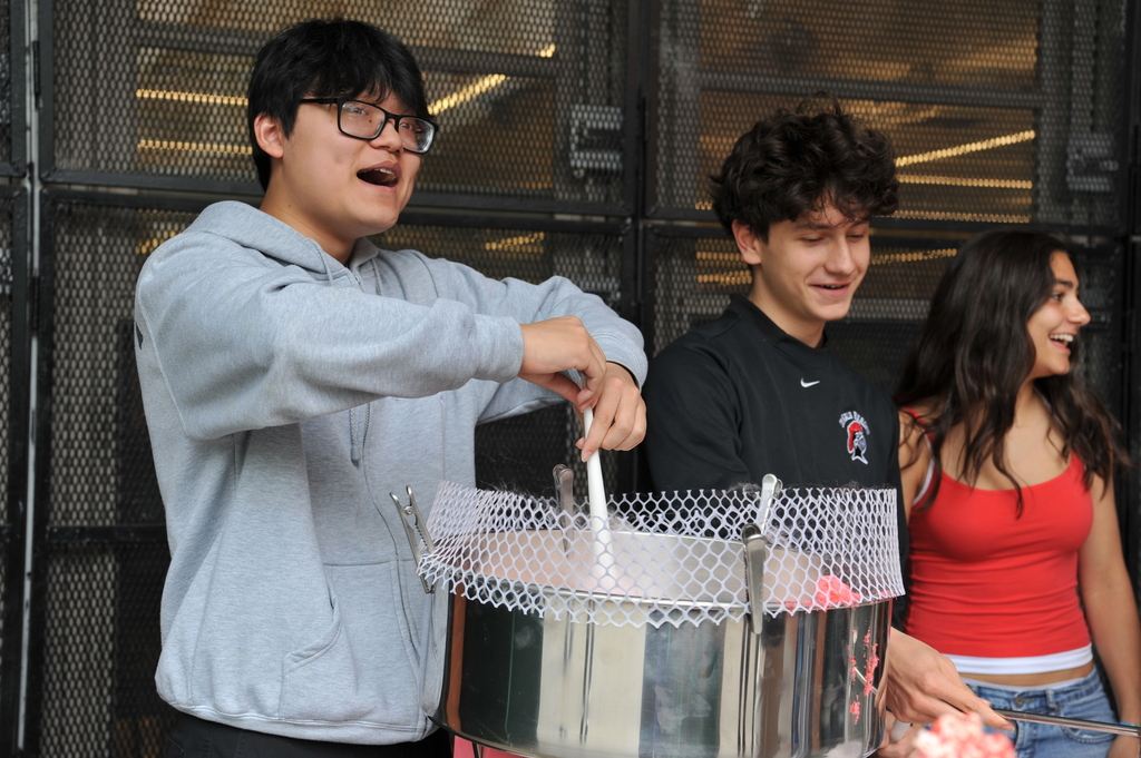 A student calls out to his “customers,” also known as other students, to serve cotton candy. 