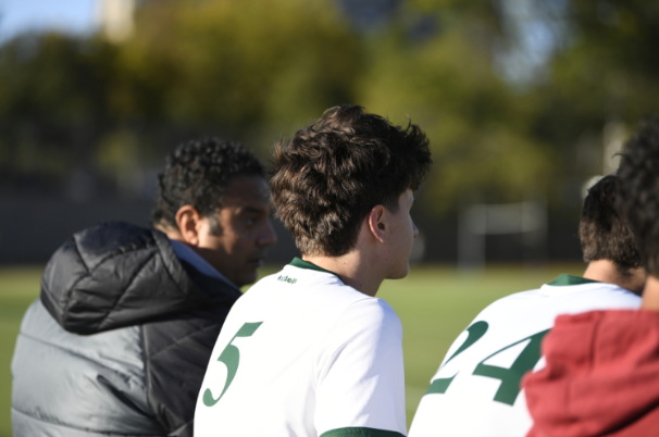 Midfielder George Petkoff (atright) discusses in game strategy with Coach Khaled Mahmoud (at left).