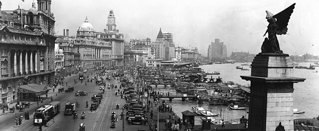 Pictured is a photo taken by a U.S Military Camera installation in 1930’s Shanghai. This photo was taken in the Bund, a protected historical waterfront that had been used as a port for many years. From 1860 to1930, the Bund served as one of the preeminent naval trading ports in all of China. 
