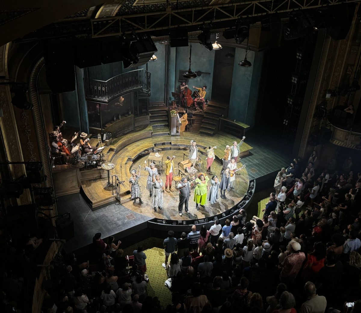 Hadestown’s uniqueness lies in a few components: its blend of jazz and contemporary musical styles, its different approach to a classic Greek myth, and the set choices. A live orchestra is positioned around the circular, rotating stage and incorporated into the story. The theatre is one of the smaller Broadway theaters in the area, seating 975 guests. (Photo Credit: Nicole Persaud; used by permission)
