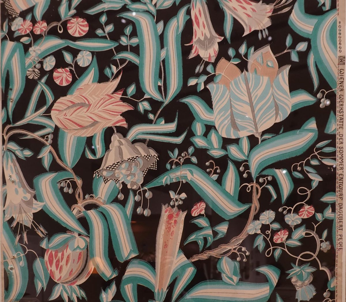 Pictured is a wallpaper design entitled 'Summer,' which was created by Dagobet Peche for the Wiener Werkstätte in 1922. At the Neue Gallery, a variety of textiles and wallpaper designs are displayed around the exhibition along with the roller printers from which they were made. (Photo Credit: Photo Credit: Geolina163, CC BY-SA 4.0 , via Wikimedia Commons)