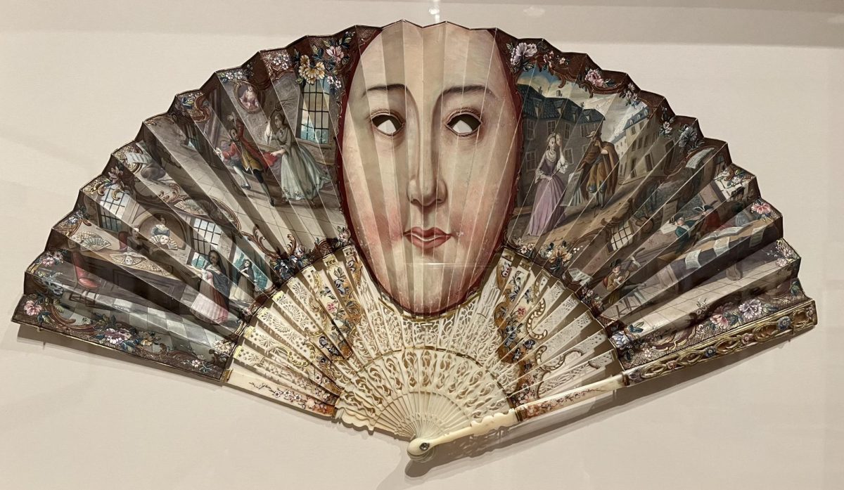 ‘Folding fan depicting a mask' (ca. 1795) was likely created for a masquerade. Looking closer, one can see scenes in a fan shop making identical fans! This is a common theme in the 'Fanmania' exhibit – fans depicting fans. 